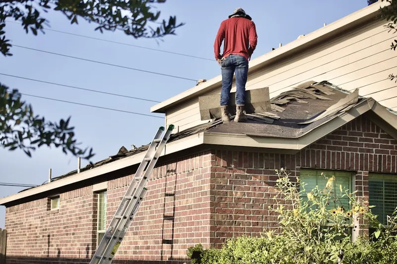 Professional roofer working on a residential roof in Orange